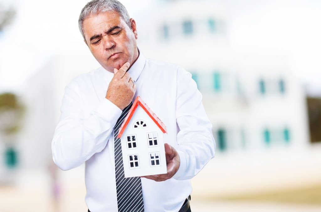 older man with house his hands 1