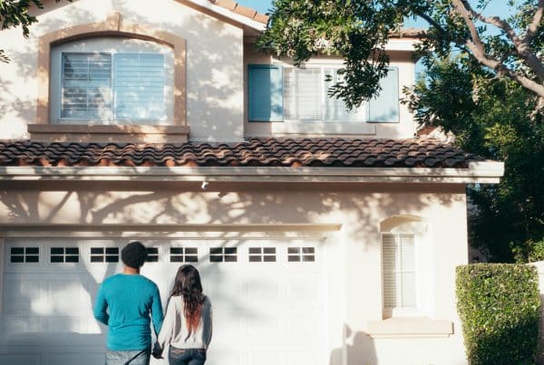 Couple walking towards a house.