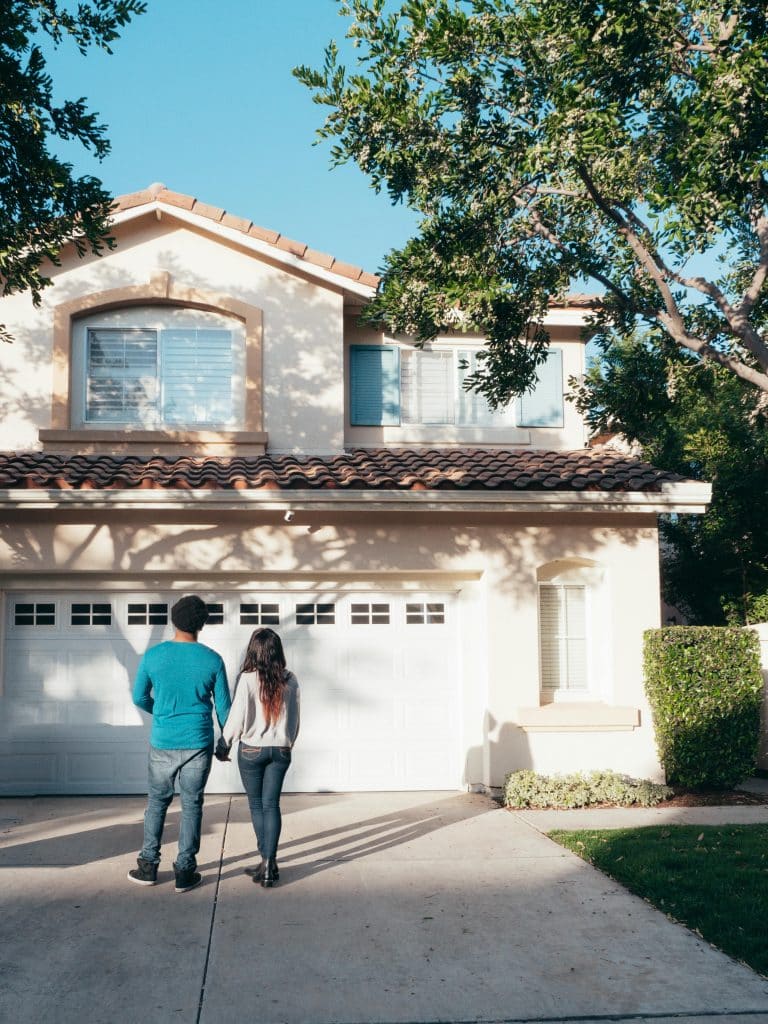 Couple walking towards a house.
